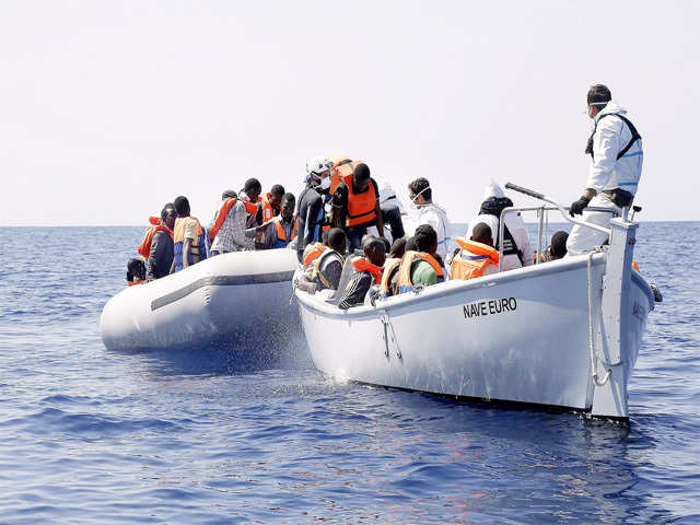 Sub-Saharan migrants being transported to Italian Navy's frigate