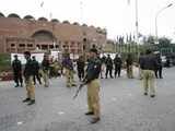 Pakistan policemen stand guard outside the Gaddafi stadium