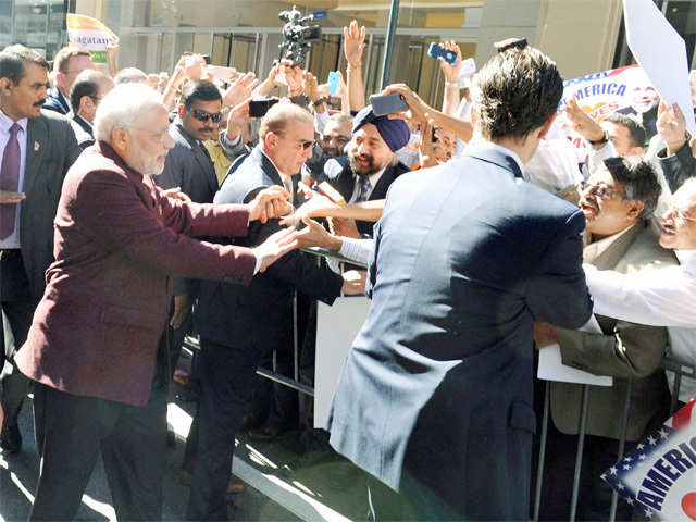 Greets people outside his hotel in New York