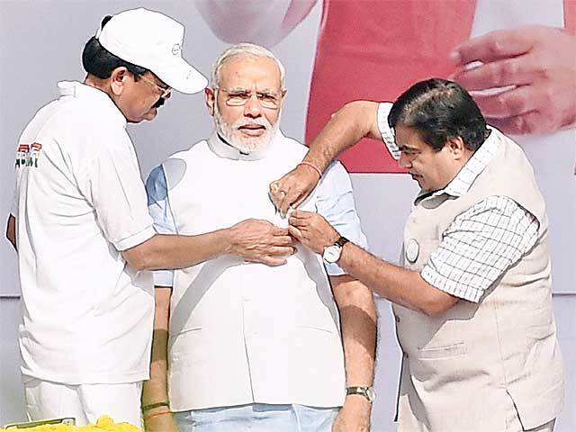 Gadkari & Naidu pinning a badge on PM