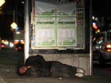 Homeless man sleeps on the pavement