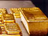 Gold trades flat, experts see more downside