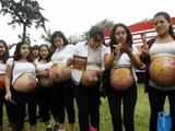 Pregnant women with their bellies painted 