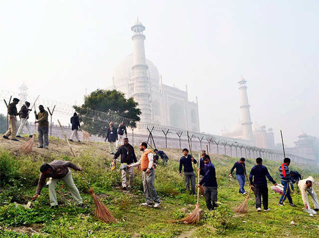 People clean surrounding areas of Taj Mahal