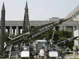 Visitor walks past models of Scud-B missile