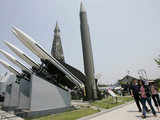 Visitors walk past N Korean Scud-B missiles