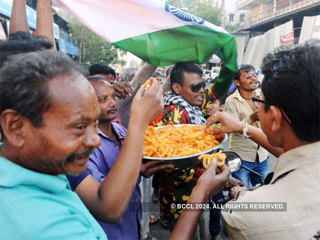 A fan shares sweets on India's victory