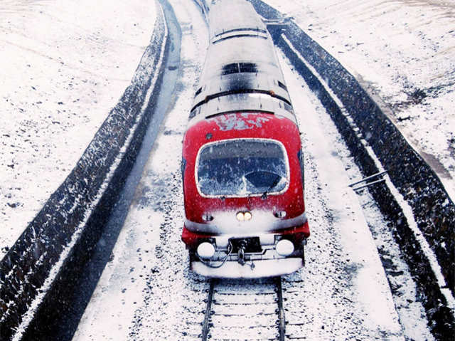Train moves through snow covered railway track