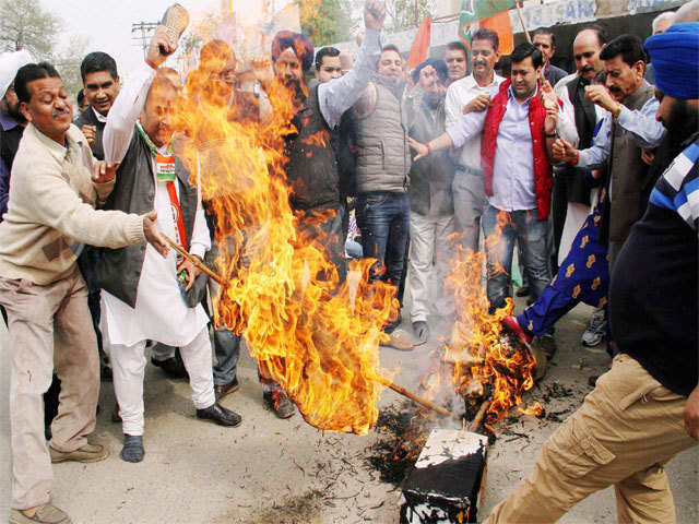 Congress activists burn an effigy of J&K Health Minister Choudhary Lal Singh