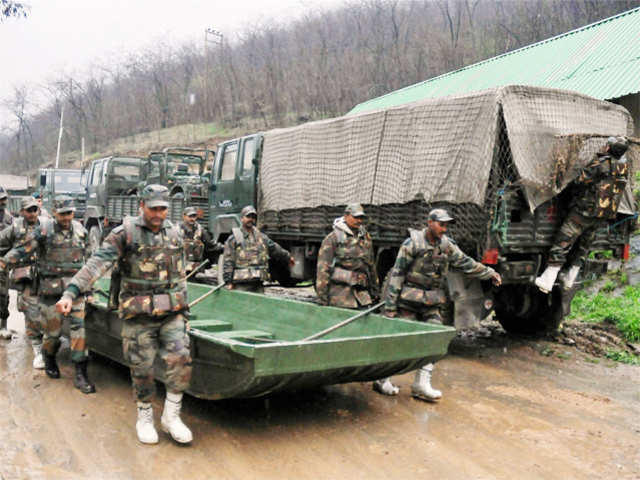 Army personnel carry a boat for rescue