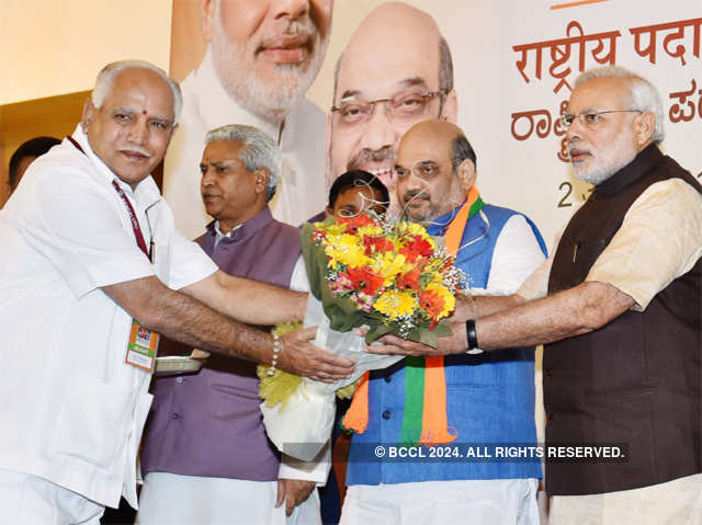 PM Modi being presented a bouquet by BJP vice-president Yeduyurappa