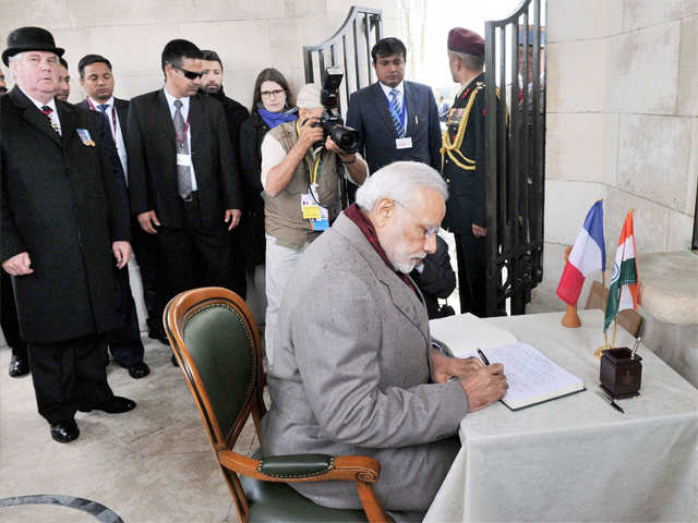 PM writes the visiters book at the Memorial
