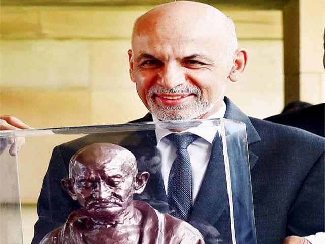 Ashraf Ghani holds a bust of Mahatma Gandhi