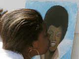 A woman kisses a picture of Michael Jackson