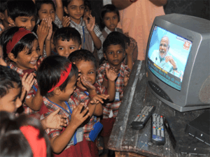 Students and teachers watch a TV broadcast of a speech marking Teachers' Day by Indian Prime Minister Narendra Modi at a S. P S Janata Vidyala at Bhandup in Mumbai. Students and teachers watch a TV broadcast of a speech marking Teachers' Day by Indian Prime Minister Narendra Modi at a S. P S Janata Vidyala at Bhandup in Mumbai.