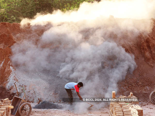 A worker mixing flyash into red soil