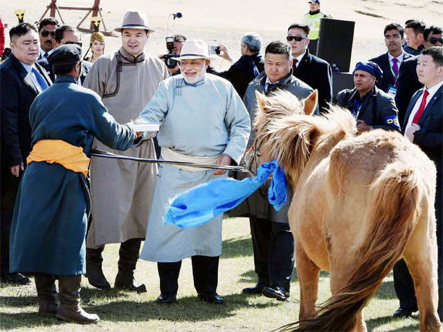 PM Modi holding a horse