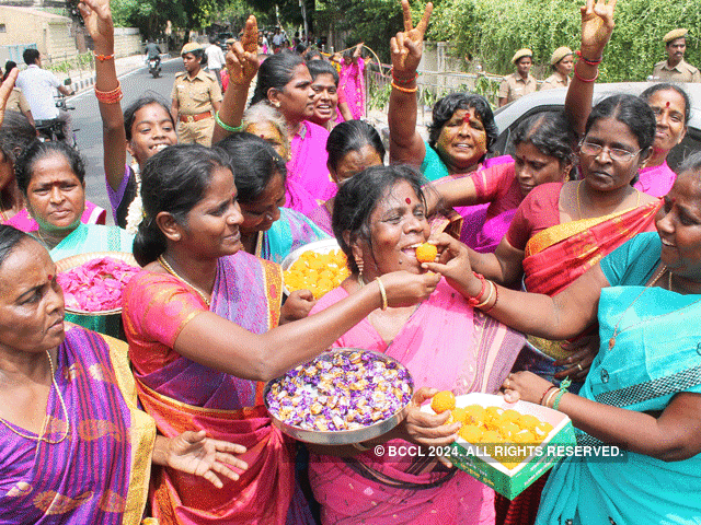 Distributing sweets to celebrate Amma's return