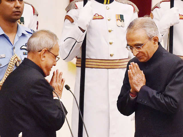 Mukherjee greets the newly sworn-in CIC