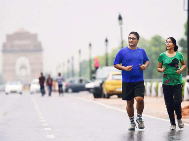 A couple run along the Rajpath