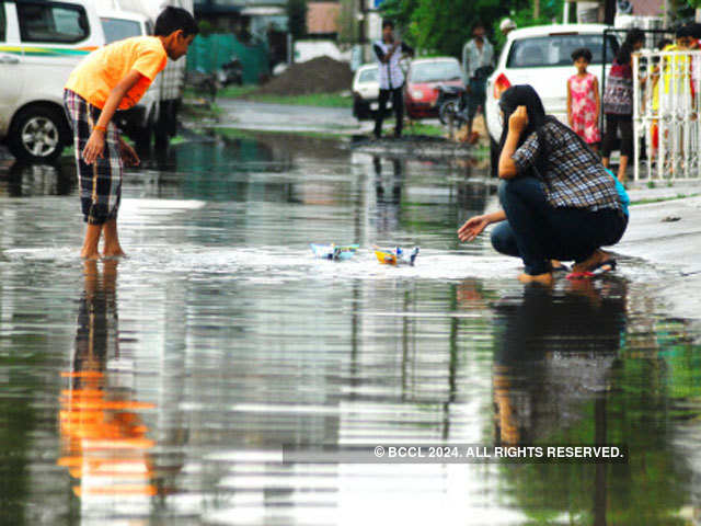 Young kids play in the rain