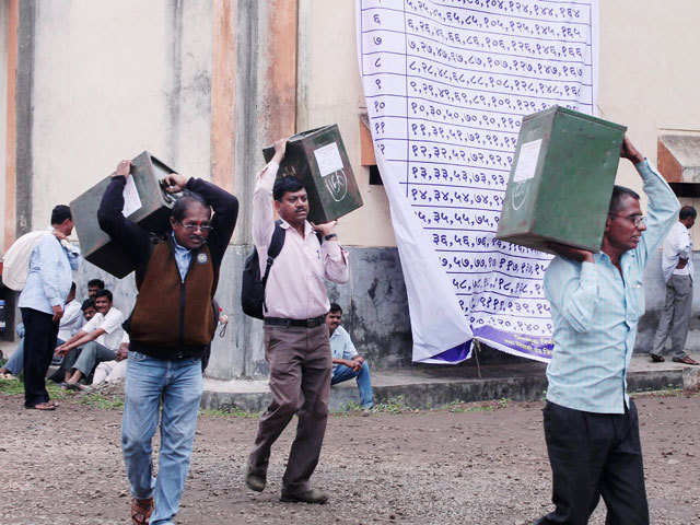 Polling officials carrying ballot boxes