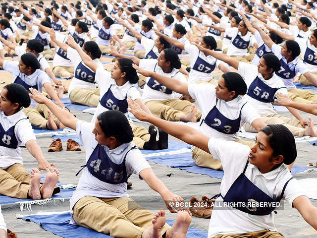 Female police cadets perform yoga