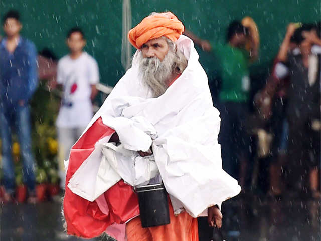 Sadhu walks in rain
