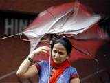 Woman adjusts umbrella