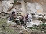 Taliban fighters talk to each other