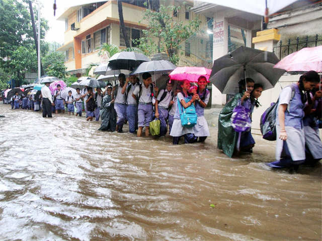 School students walk with umbrellas