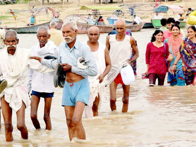 People wade through flood water