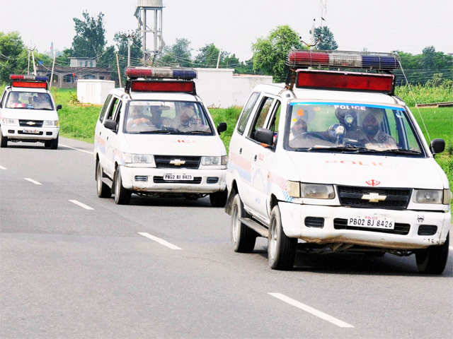 Police vehicles arrive during an encounter with militants