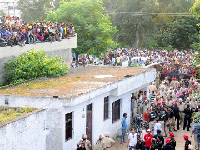 People crowd near the scene of the encounter