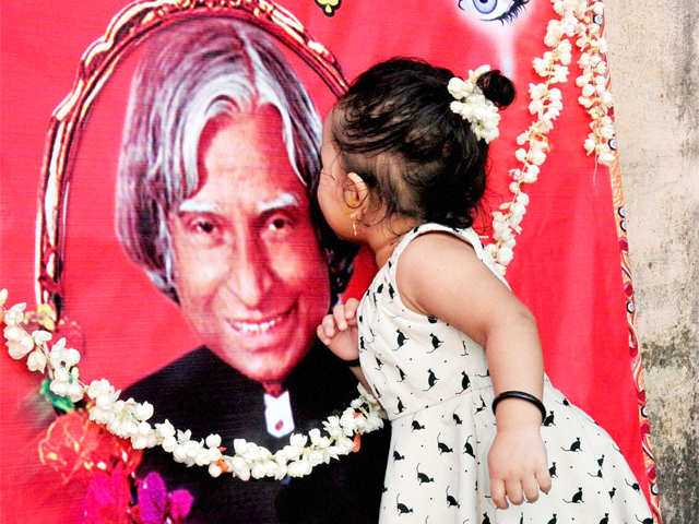 A child kisses Dr Kalam's photo