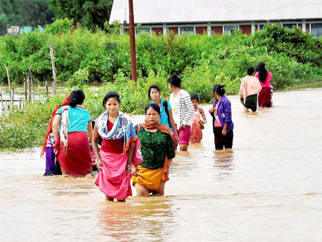 Villagers wade through floodwaters