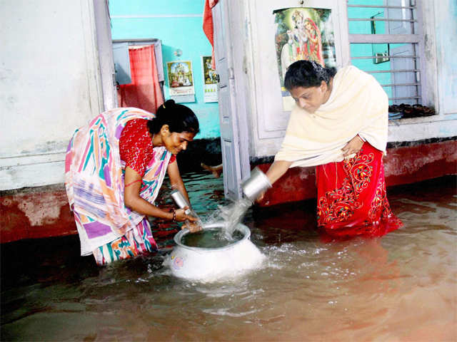 Women tries to remove floodwater