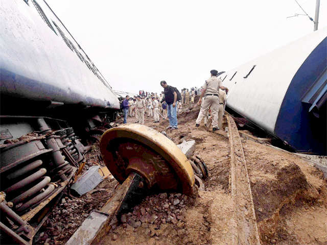 Policemen inspects the wreckage of bogies