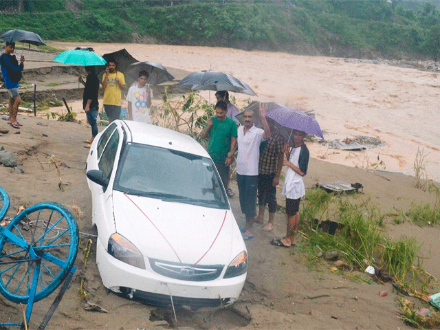 Residents gather around a flood affected area