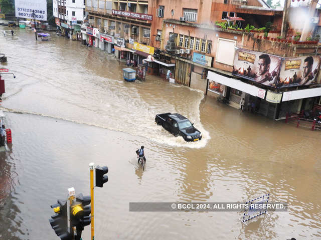 Car wades through water at Panchsheel Square