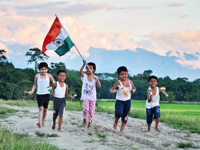 Children run with tricolour