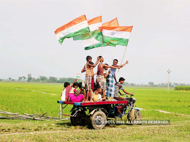 Village children hold Indian National flags