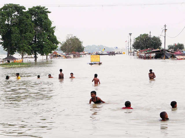 Boys playing at a flooded road