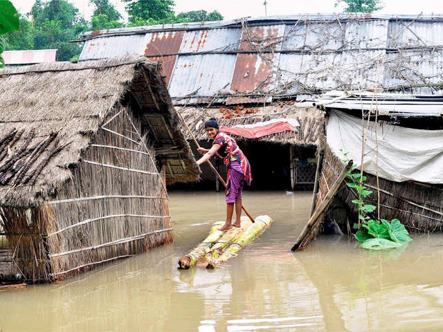 Woman crosses a flooded area