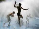 Boys cool down in a public fountain in Berlin