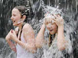 Children play under a fountain