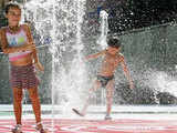 Children play at a fountain