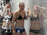 Young women cool off in a fountain