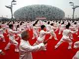 Performers in white silk perform taiqiquan