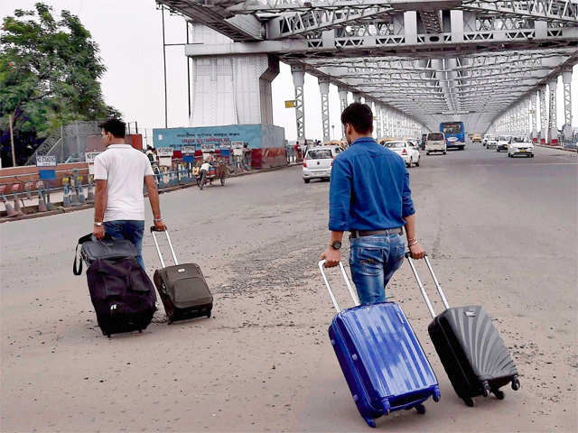 Passengers walk with their luggage